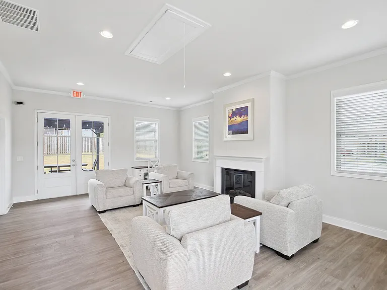 Upscale clubhouse lounge centered around a cozy fireplace.