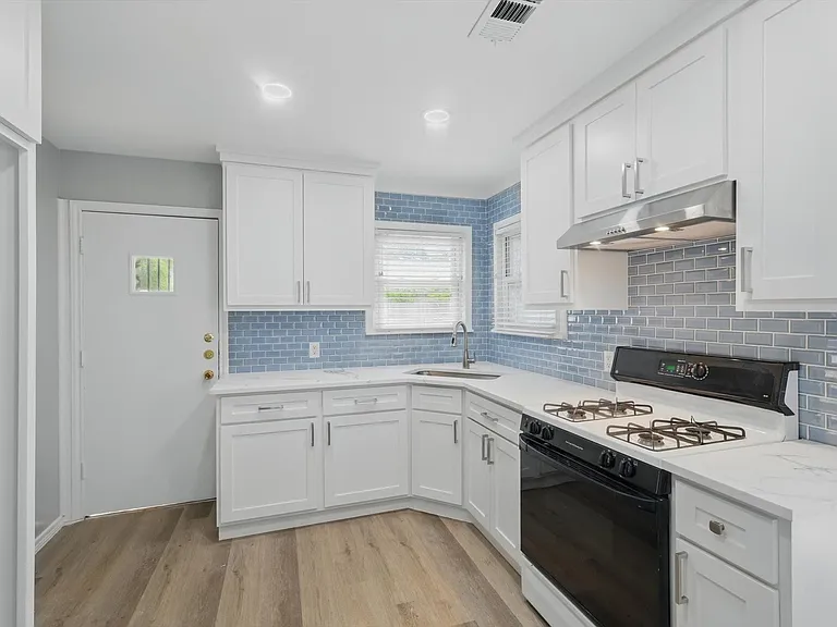 Recently updated kitchen featuring quartz countertops, white cabinets, new spacious pantry and dedicated utility closet. Washer and dryer included.