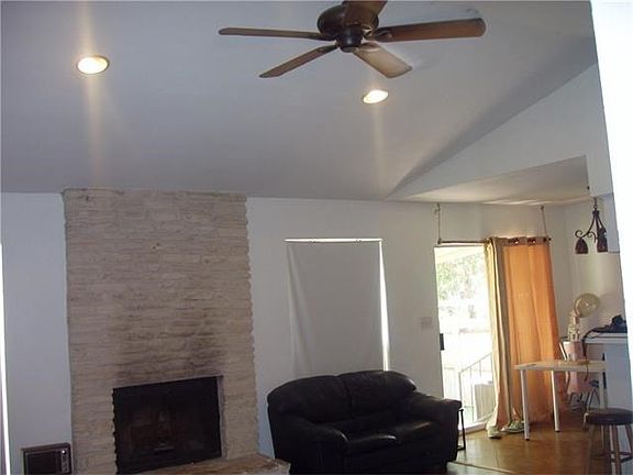 interesting high ceiling in living area. shows back sliding door to covered patio.