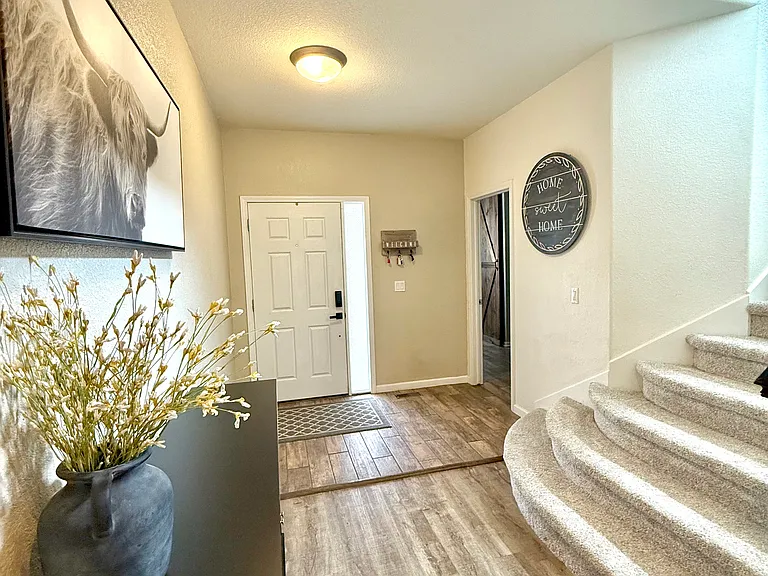 Entryway - view towards front door and main floor primary bedroom