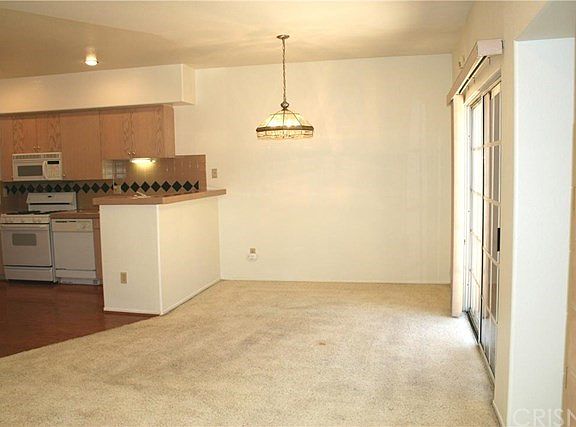 Formal dining area & open kitchen. The slider goes to the pr