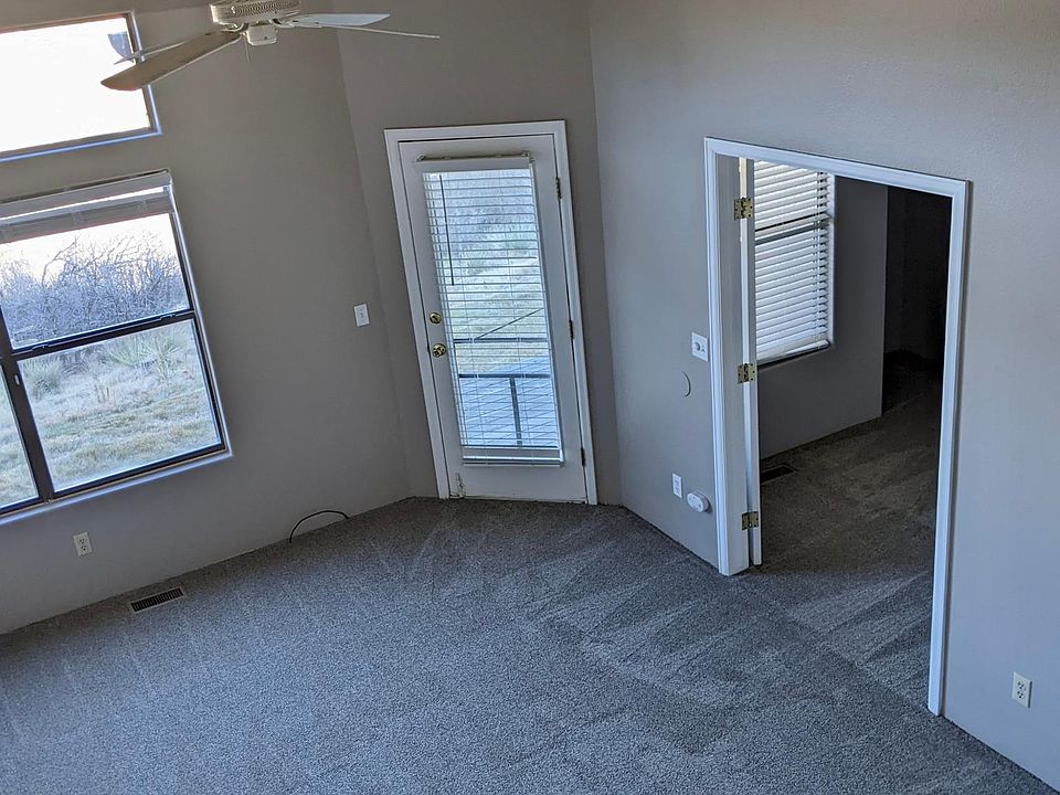 Living Room w/ vaulted ceilings (2nd bedroom/office entrance & back porch access also pictured)