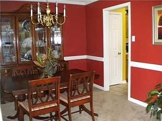Elegant dining room with crown molding and chair rail