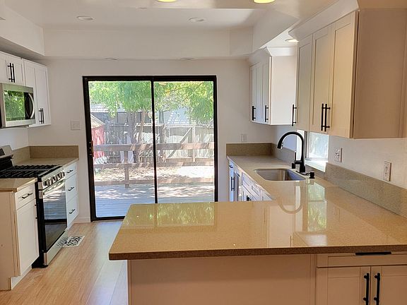 UPDATED KITCHEN - cabinets, appliances (gas range and oven, microwave, stainless dishwasher, newer QUARTZ counters, newer faucet, newer deep farmhouse sink...and we added a large pantry just left of photo.