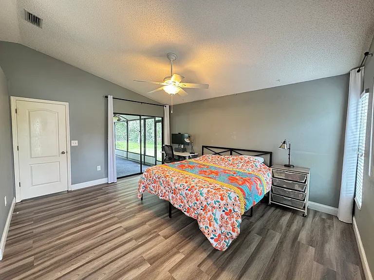 Master bedroom, connected to the left is the screened-in lanai