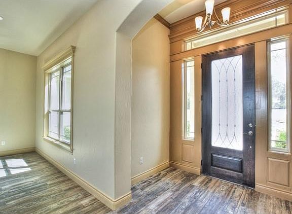 Custom Wooden Front Door with Wrought Iron design is very inviting indeed.