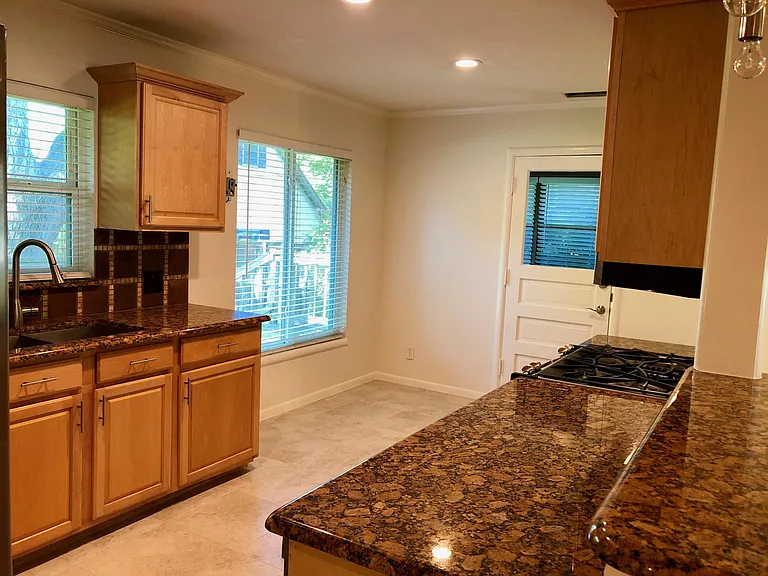 Kitchen facing to the mudroom / laundry room (washer and dryer hook ups). Access outside through mudroom.