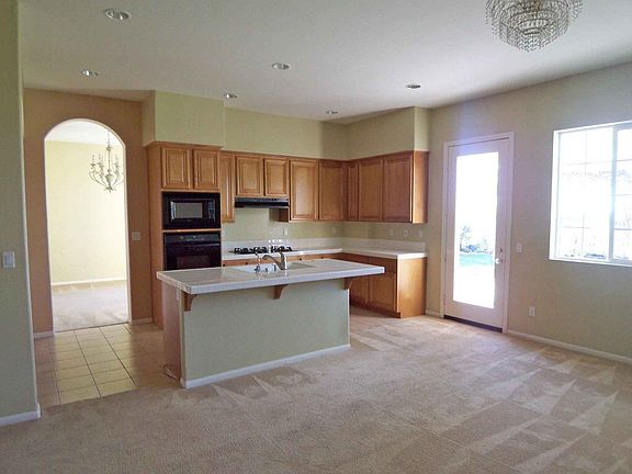 A second view of the kitchen with door leading to the patio