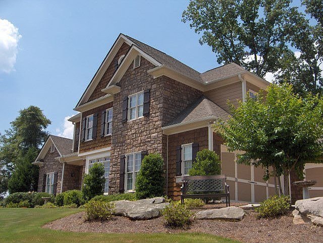 Beautifully landscaped executive home with stone and cedar shake detail