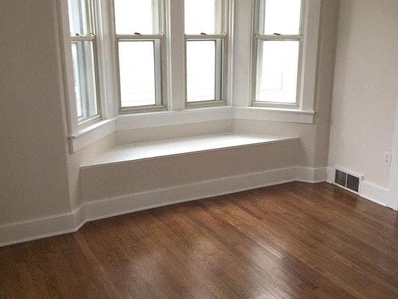 Master bedroom features bay window with bench.