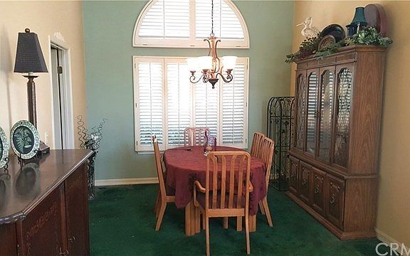 The formal dining area is accented with an arched window with shutters throughout the home