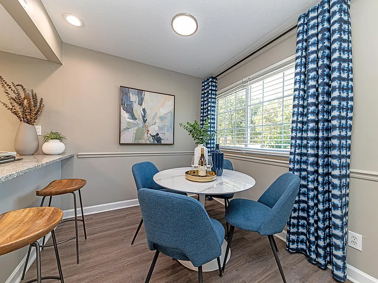 Dining area with hardwood-style flooring and overhead lighting