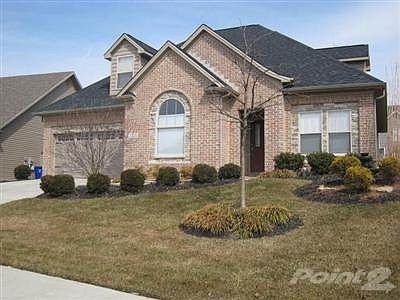 Professional landscaping in the front yard and upgraded gara