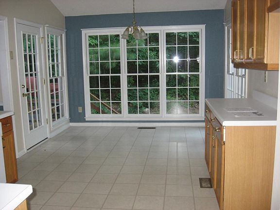 Large kitchen with dining area surrounded by full-length win