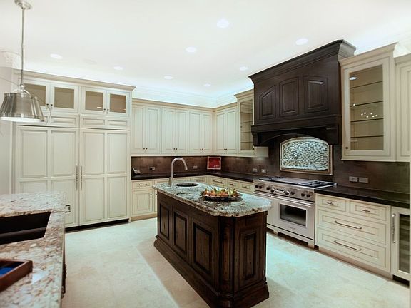 Subzero and Wolf kitchen with hidden pantry that features dishwasher and sink