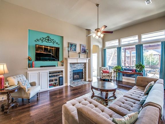 Spacious family room has a lovely view of the backyard pool and patio.  Family room also features a built in cabinet for your TV and electronics, plus a gas log fireplace