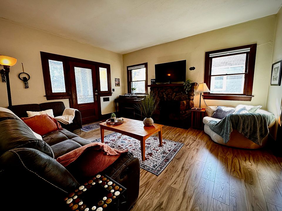 Furnished living room. Reclining leather sofa, loveseat, and large round chair. New flooring installed 2025 entire house. New blinds 2025. Piano works and is tuned.