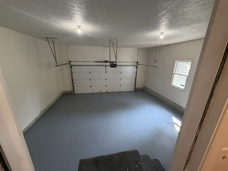Oversized 2 car garage with just-painted doors and floor. Who likes a clean garage?