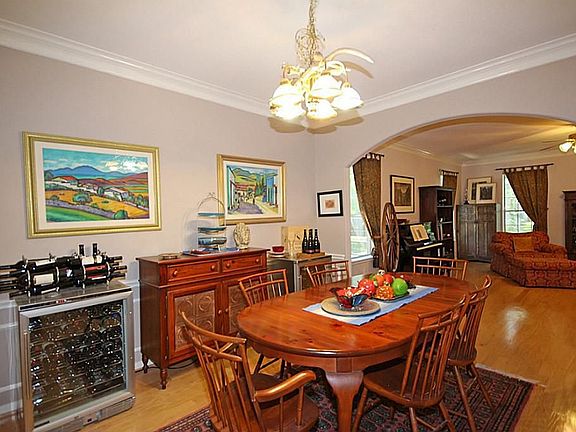 Pretty moldings and gleaming wood floors continue into the Formal Dining Room.