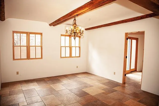 Large, light-filled dining room with office/3rd bedroom and second patio off to right.