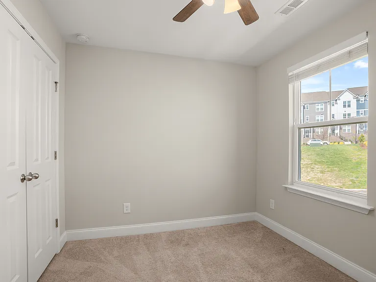3rd bedroom with ceiling fan and window blinds and carpeting