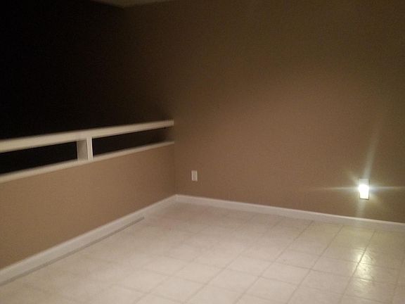 Dining room - photo taken at night. The railing overlooks living room where there is lots of light from south /west facing floor to ceiling windows