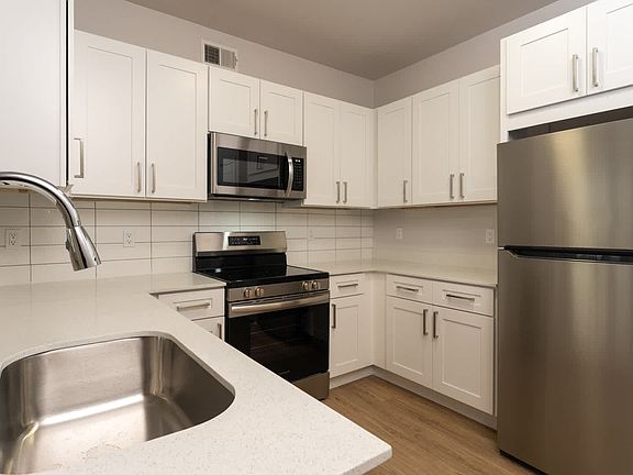Kitchen with island and hard surface flooring