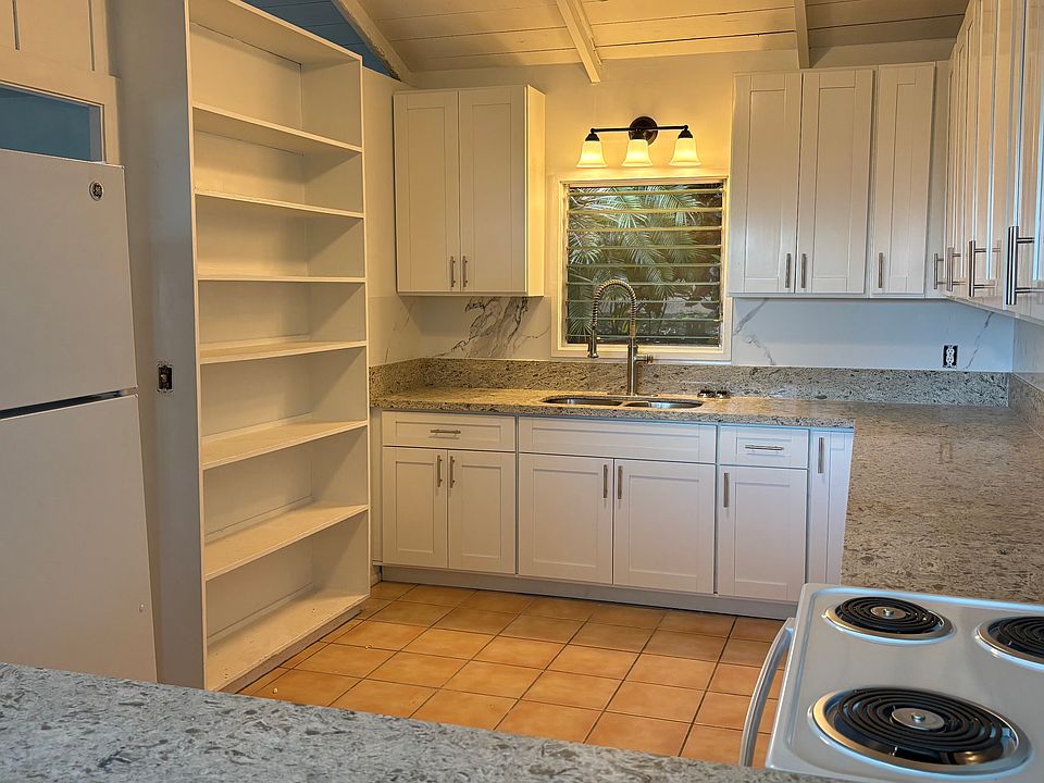 Newly installed "White Shaker" cabinets! New countertop, stove, refrigerator, and lighting! Also has breakfest bar with an ocean view!