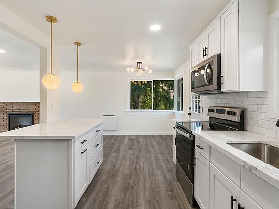 Chef's Kitchen: quality hardwood cabinets with ton of storage, quartz countertop, brand new appliances, functional island.