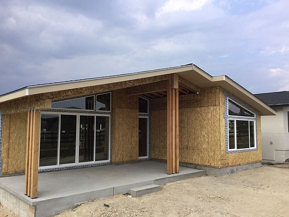 Rear covered patio underway. Photo of home under construction