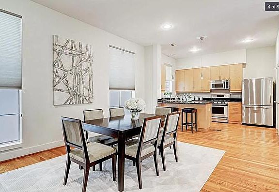 Dining room with kitchen in background
