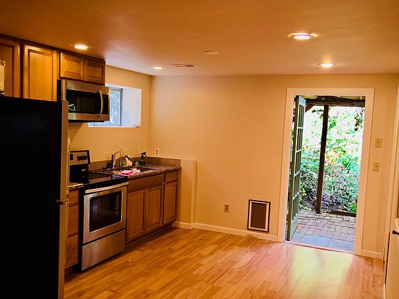 downstairs kitchen toward a small fenced area entrance and extend to a huge parklike back yard