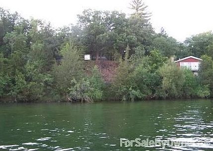 Looking at the lot from the lake.
						:
						Lot sits up from the lake approximately 30' rise.