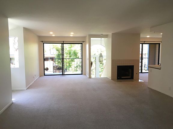 Living and dining area. Lots of windows/natural light