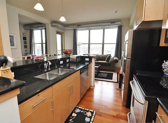 Kitchen with 2-tiered 9' long center island (Taken from unit above the condo available for rent/same configuration)