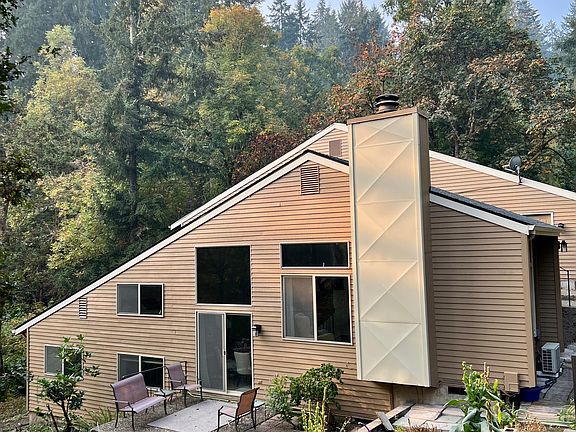 Beautiful South Hills 2+ bedrooms, 2 bathrooms multi level home with wildflowers on terraces. Deer graze on the lawn.