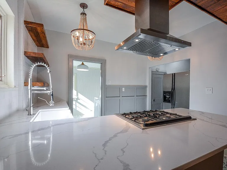 Kitchen with chef's sink and huge island, there is enough space to put counter height stools.