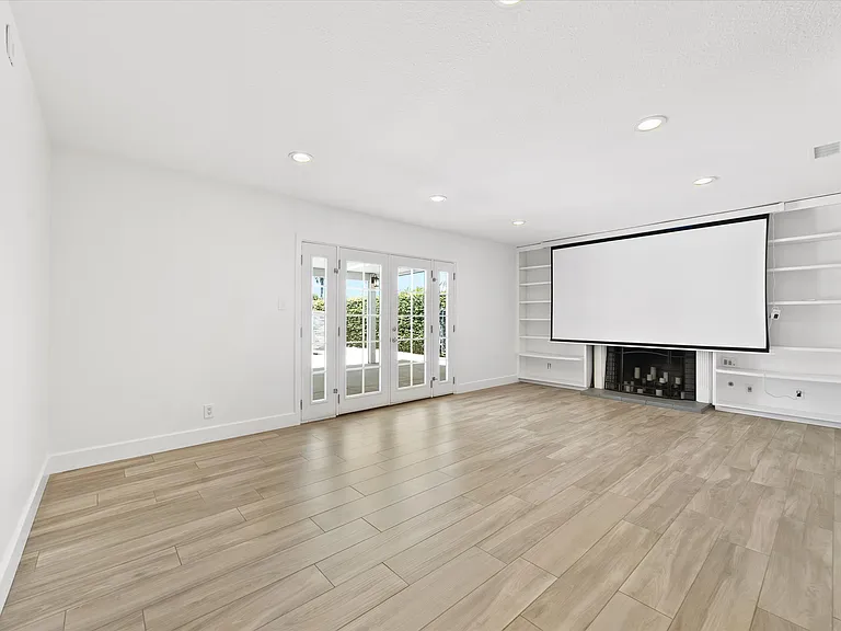 Living Room with screen down. Projector plug and wiring mounted on opposite wall