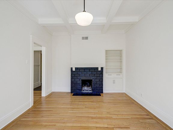 Living Room w/ box ceilings and decorative fireplace