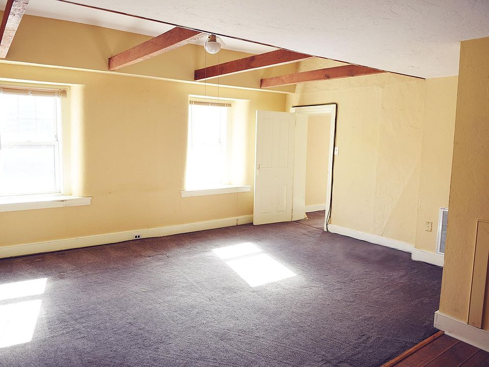 Large Living room with lots of natural light and the door to bedroom