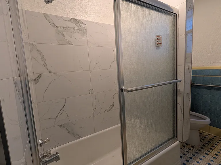 upgraded bathroom with a glass wall/shower feature