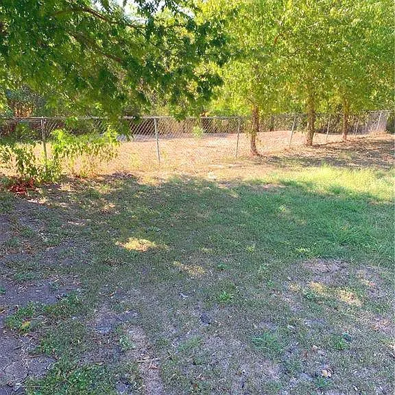 Very large backyard is fully fenced and not shared. Peaceful woods and dry creekbed beyond the fence. No neighbors behind you