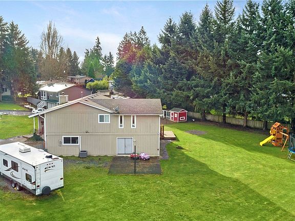 Nestled on a privately situated lot at the end of a cul-de-sac, this back yard offers so much space to roam & play! Offering RV parking galore, a sport court/patio plus upgraded play toys