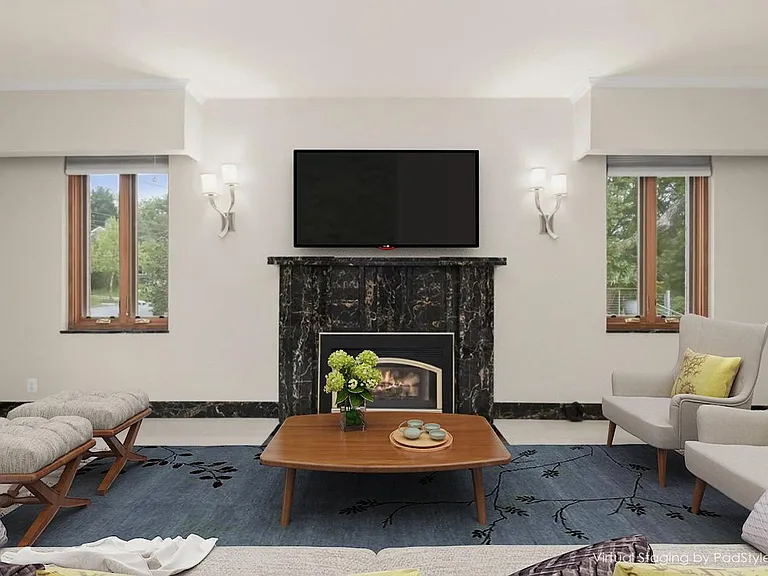 9-foot ceilings, formal living room with gas log fireplace and multiple Pella wood casement windows on front, side, and rear walls