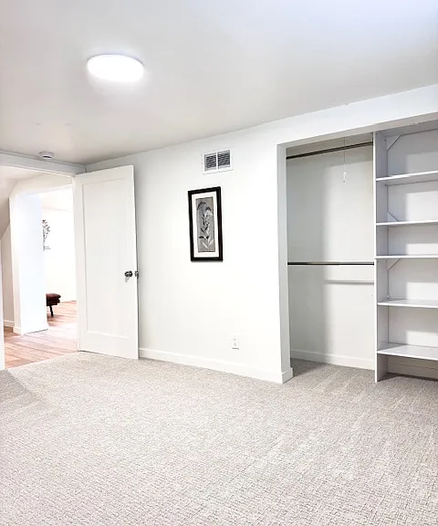 Bright and spacious room A, 180 sqft. with 2 wall art and a big closet. Window facing west street.