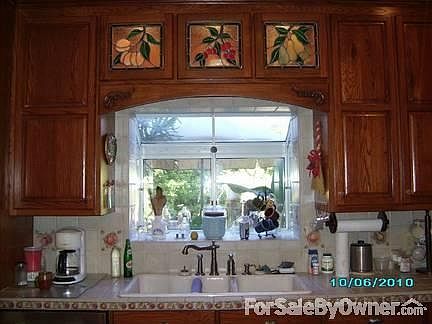 Stained-glass Doors over Kitchen Sink : A garden window behind kitchen sink