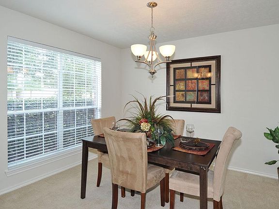 Spacious formal dining room with plenty of natural lighting to entertain