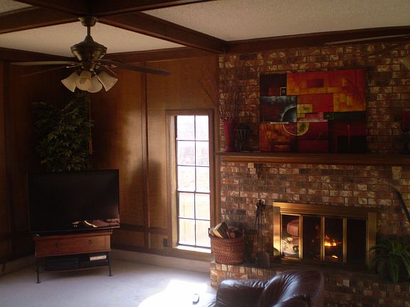 Beautiful brick fireplace. Tall ceiling with wood beams.