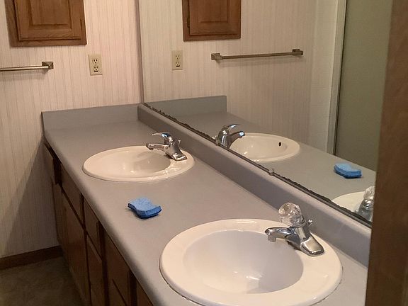 Lower level has large bathroom with double sinks, tile shower and new flooring