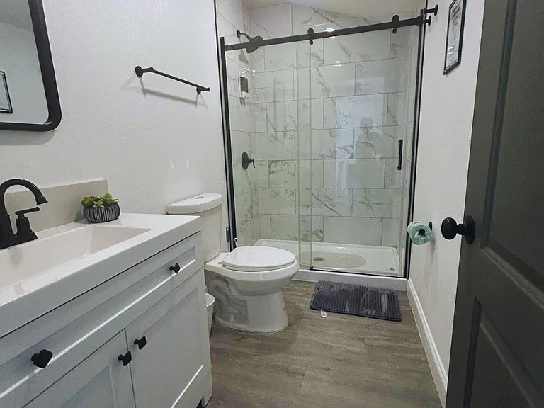 Bathroom featuring towels, mirror and vanity cabinet below.